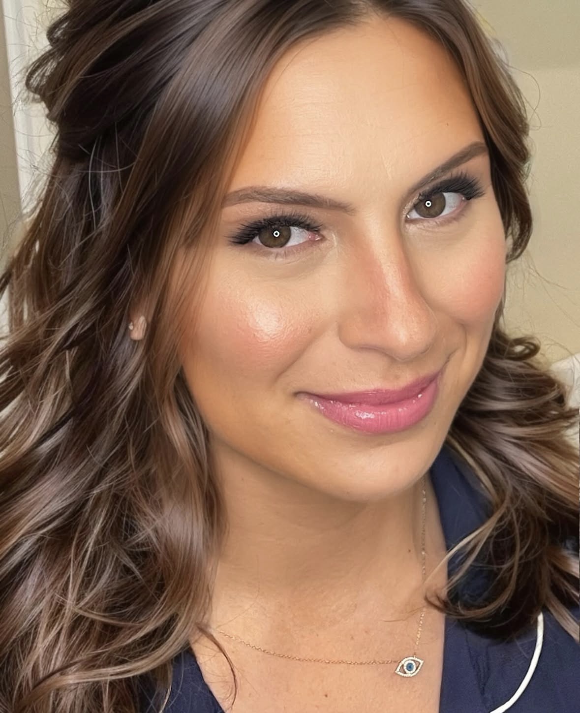 Radiant bride with soft waves and rosy glow