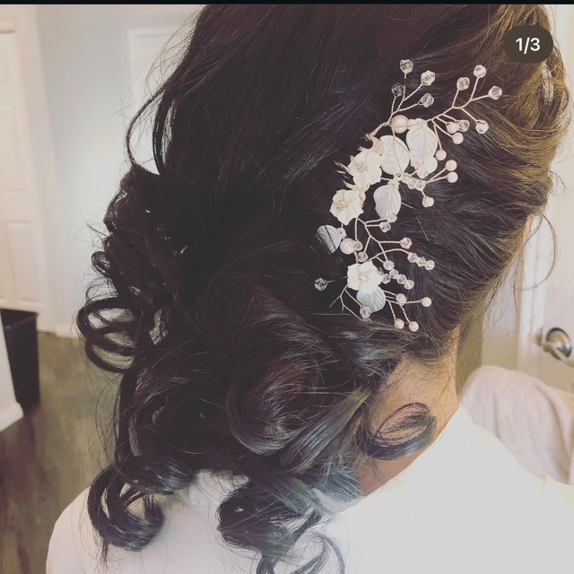 Elegant bridal updo with floral hair piece